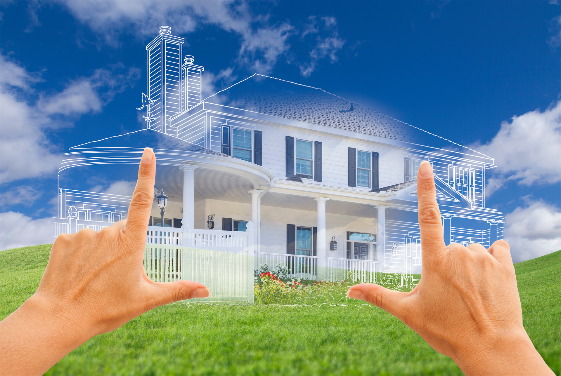 Hands framing a hand-drawn sketch of a dream home overlaid on a real house